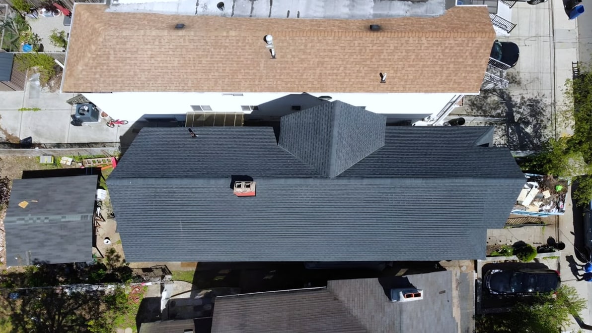 aerial top-down view of new dark gray shingle roof